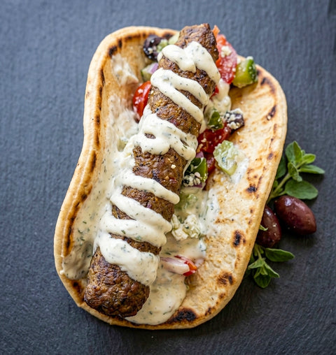 Greek-Style Lamb kofta in a Flat Bread with a Mint Yogurt & Greek salad