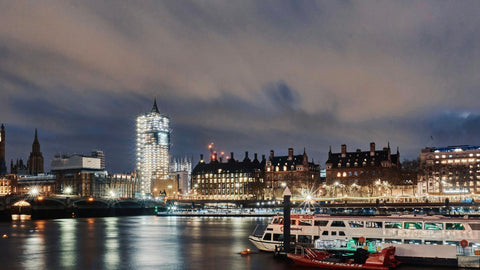 Yachts on the River Thames with the London skyline at night